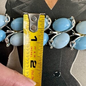 K&ouml;nnte beinhalten: Eine blaue und silberne Statement-Halskette mit ovalen Steinen. Die Halskette wird mit einem Ma&szlig;band gemessen und ist 5 cm lang.