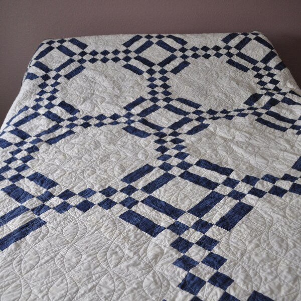 A handmade blue and full size quilt