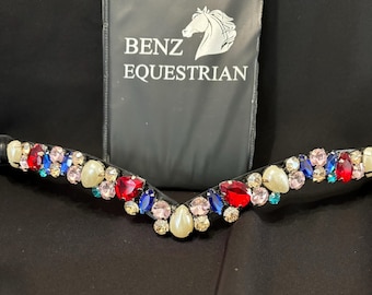May include: A black leather browband with a V-shaped design adorned with red, blue, pink, and white crystals. The browband is decorated with a variety of crystal shapes, including round, square, and teardrop.