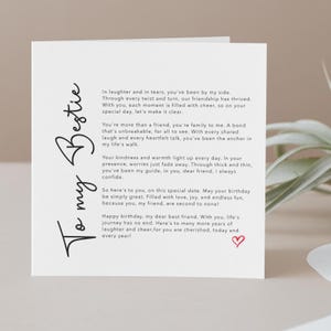 Greeting card with the title “To My Bestie” written in elegant script at the side. The card features  a heartfelt poem in the centre, expressing love, gratitude, and friendship. There's a small heart illustration at the bottom.