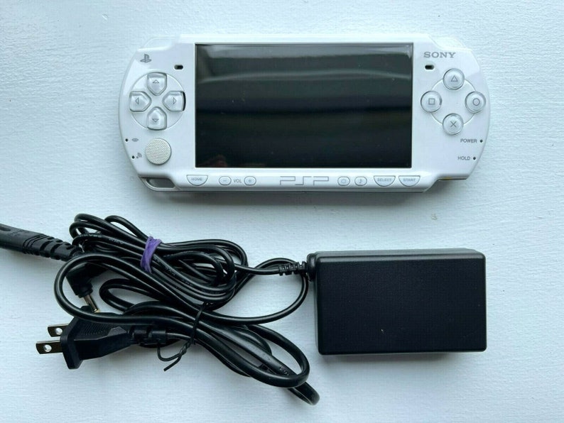 Sony PSP-2000 Console 100% Authentic, WiFi enabled Good Condition Comes with Charger New Battery Tested, Cleaned & Working Ceramic White