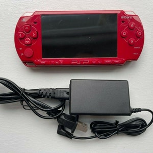 Sony PSP-2000 Console 100% Authentic, WiFi enabled Good Condition Comes with Charger New Battery Tested, Cleaned & Working Deep Red