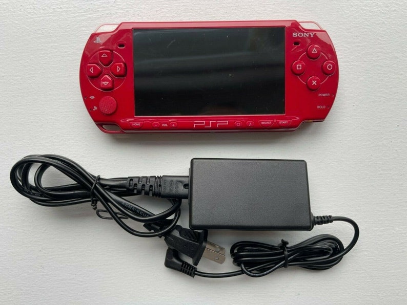 Sony PSP-2000 Console 100% Authentic, WiFi enabled Good Condition Comes with Charger New Battery Tested, Cleaned & Working Deep Red