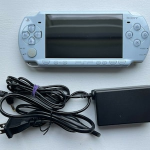 Sony PSP-2000 Console 100% Authentic, WiFi enabled Good Condition Comes with Charger New Battery Tested, Cleaned & Working Felicia Blue