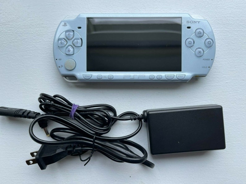 Sony PSP-2000 Console 100% Authentic, WiFi enabled Good Condition Comes with Charger New Battery Tested, Cleaned & Working Felicia Blue