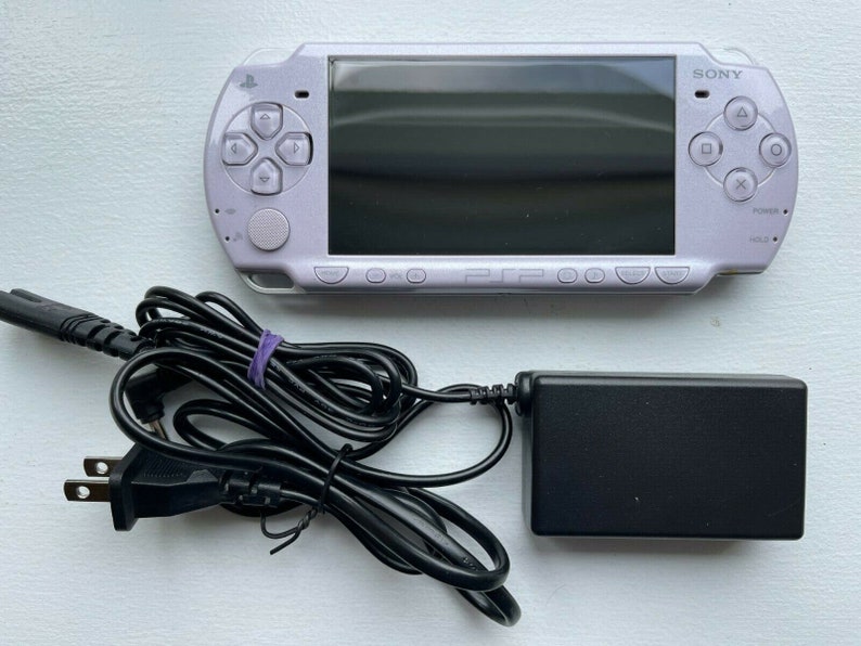 Sony PSP-2000 Console 100% Authentic, WiFi enabled Good Condition Comes with Charger New Battery Tested, Cleaned & Working Lavender Purple