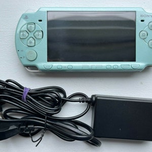 Sony PSP-2000 Console 100% Authentic, WiFi enabled Good Condition Comes with Charger New Battery Tested, Cleaned & Working Mint Green