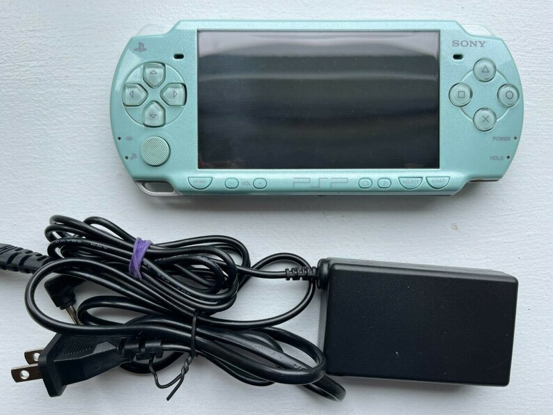 Sony PSP-2000 Console 100% Authentic, WiFi enabled Good Condition Comes with Charger New Battery Tested, Cleaned & Working Mint Green