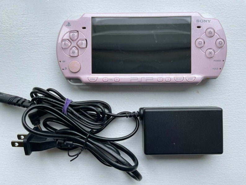 Sony PSP-2000 Console 100% Authentic, WiFi enabled Good Condition Comes with Charger New Battery Tested, Cleaned & Working Rose Pink