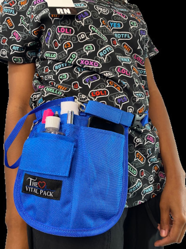 May include: A blue medical utility belt with multiple pockets and a strap. The belt has a label that says "The Vital Pack" with a heart symbol. The belt is worn by a person with a black shirt with a pattern of speech bubbles with various words and phrases.