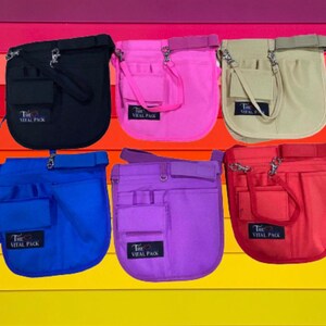 May include: Six different colored utility belts with multiple pockets and a strap. The belts are black, pink, beige, blue, purple, and red. Each belt has the text "The Vital Pack" printed on it.