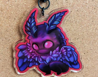 May include: A purple and blue moth-like creature with large wings and glowing pink eyes. The creature is depicted on a clear acrylic keychain with a red border.