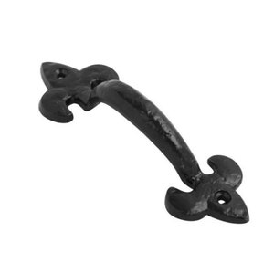May include: Black cast iron door handle with a fleur-de-lis design on each end.