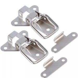May include: Two silver-toned metal clasps with a spring-loaded latch and a D-shaped handle. Each clasp has a triangular base with three holes for mounting. Two additional silver-toned metal plates with two holes each are included.