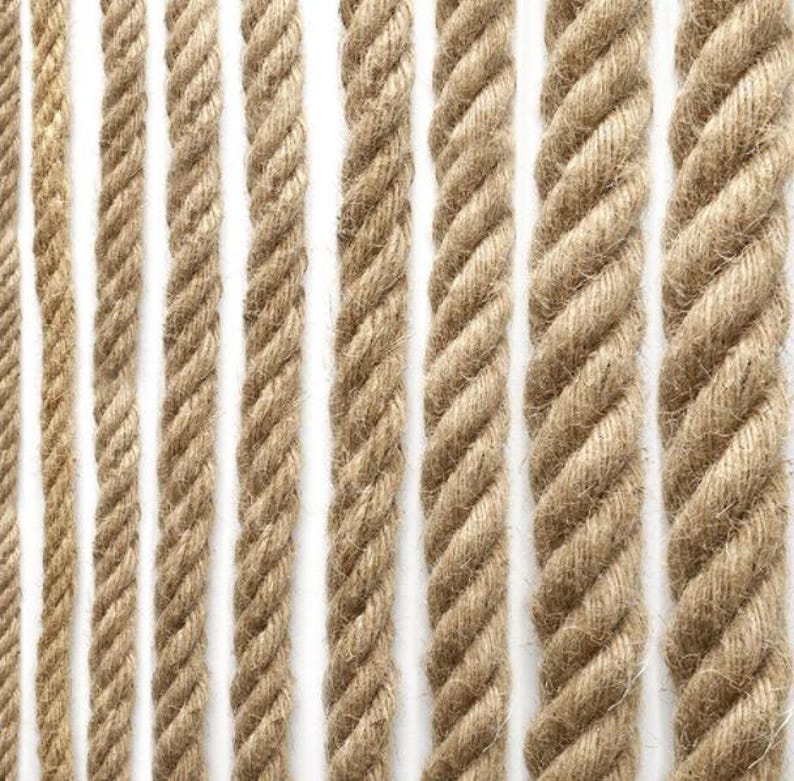 May include: A close-up of various natural fiber ropes in different thicknesses. The ropes are made of a natural material, such as jute or hemp, and have a rough, textured surface. The ropes are arranged in a vertical pattern, with each rope running from the top to the bottom of the image.