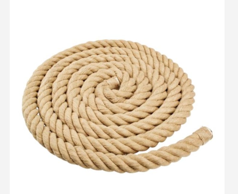 May include: A thick, natural-fiber rope coiled into a circle. The rope is made of a natural material, such as jute or sisal, and has a rough, textured surface.