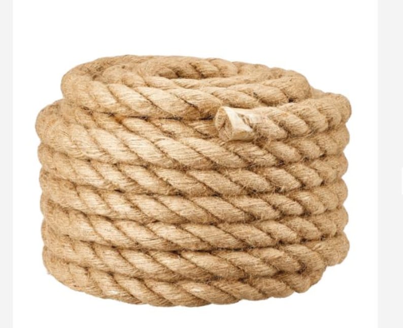 May include: A thick, natural rope made of jute fiber. The rope is coiled and ready for use. It is a natural brown color and has a rough texture.