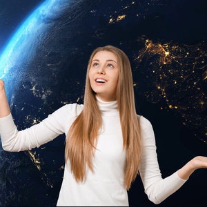 May include: A woman with long blonde hair is looking up at a bright light in front of a blue and green globe. The globe is surrounded by a dark blue background with stars and city lights.