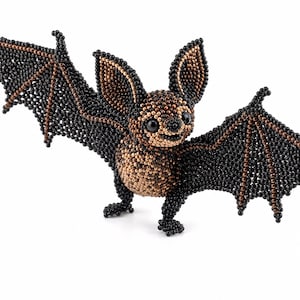 May include: A bat figurine crafted from small beads in shades of black and metallic bronze. The bat is depicted with its wings spread wide, featuring black wing membranes and bronze-colored structural lines, with a bronze chest and ears.