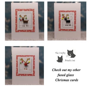 May include: Three white greeting cards featuring a central rectangular panel with a red snowflake pattern. Each card displays a hand-drawn animal illustration with attached glass beads. Text reads: The Crafty Black Cat Check out my other fused glass Chrismas cards.