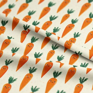 May include: A repeating pattern of smiling orange carrots with green tops on a cream background. Some carrots are whole, while others are cut in half or in pieces. The design has a whimsical, cartoonish style.
