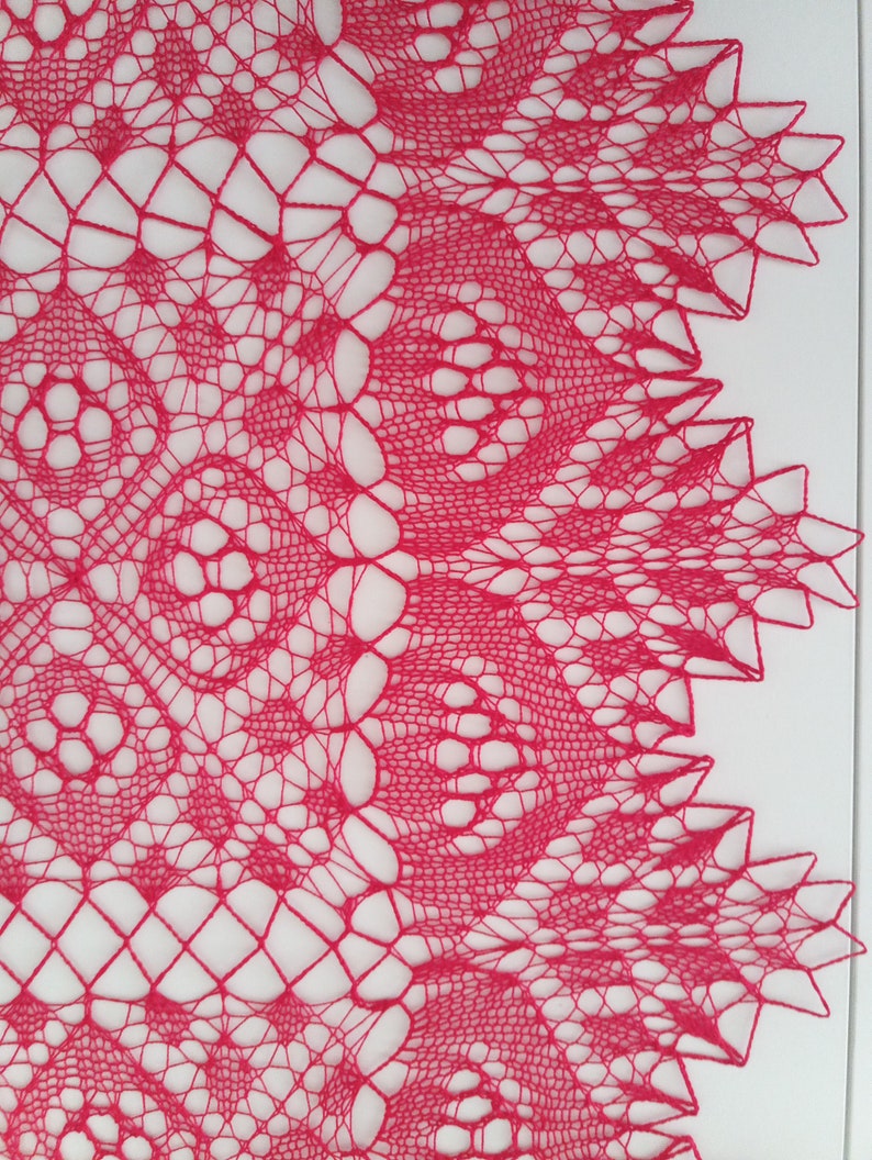 May include: A delicate pink crocheted lace doily with a circular design and intricate patterns.