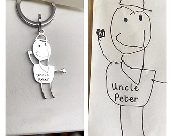 May include: A silver keychain with a child's drawing of a person wearing a hat. The drawing is engraved on the keychain and says "Uncle Peter".