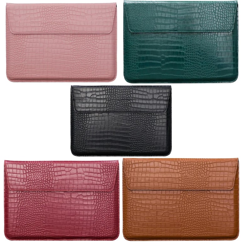 May include: Five laptop sleeves in different colors: pink, green, black, burgundy, and brown. Each sleeve has a crocodile-embossed texture and a flap closure.