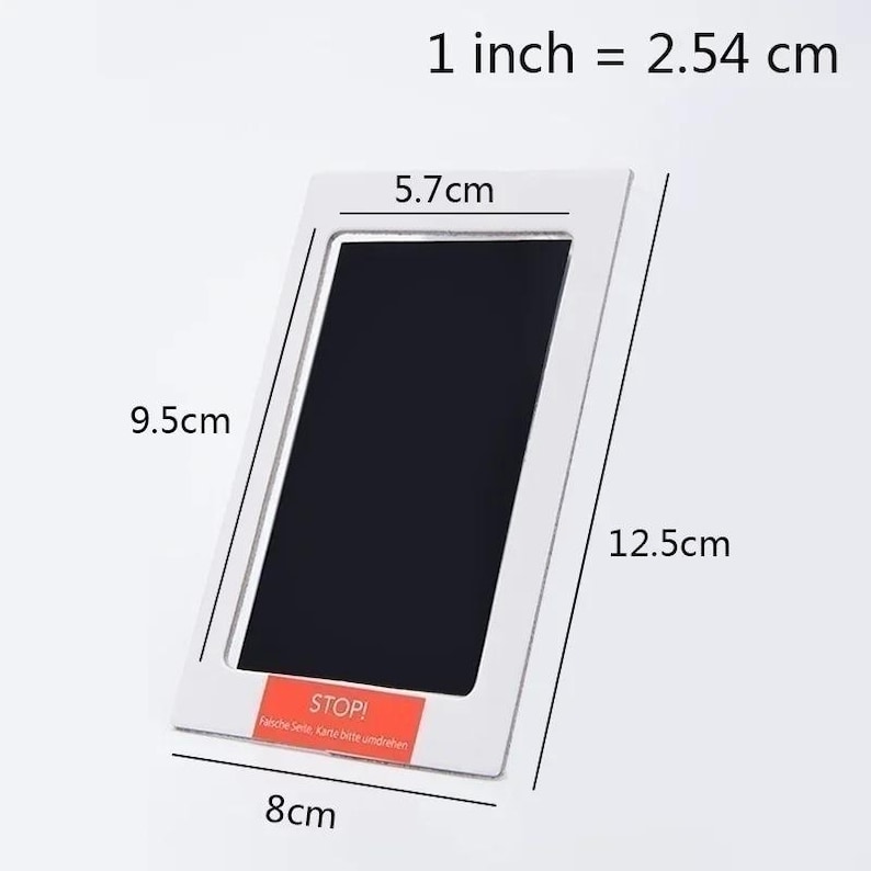 May include: A white rectangular baby handprint and footprint kit. The kit measures 5.7cm x 9.5cm (2.2 x 3.7 inches) and 8cm x 12.5cm (3.1 x 4.9 inches). The kit has a black area for the print and the text "STOP!" on a red label.