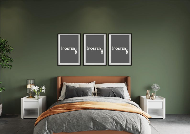 May include: Three rectangular black picture frames arranged horizontally on a dark olive green wall above a bed. Each frame contains a dark grey insert with the white text "YOUR POSTER HERE" oriented vertically along the right side of the frame.