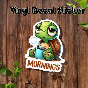 May include: A vinyl decal sticker featuring a cartoon turtle holding a cup of coffee with the text "MORNINGS" below it.