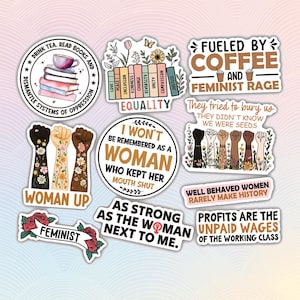 May include: Set of 9 feminist themed stickers with colorful floral designs and empowering slogans. Stickers include "Drink Tea, Read Books and Dismantle Systems of Oppression", "Woman Up", "Feminist", "Fueled by Coffee and Feminist Rage", "They tried to bury us, they didn't know we were seeds", "I won't be remembered as a woman who kept her mouth shut", "As strong as the woman next to me", "Well behaved women rarely make history", and "Profits are the unpaid wages of the working class".