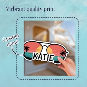 May include: A sticker featuring sunglasses with a sunset design, palm trees, and the name "KATIE" in white. The sticker has a vibrant quality print and is designed for a custom name.