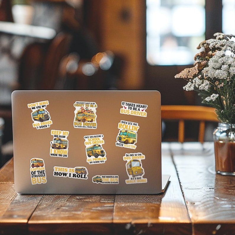 May include: A set of ten yellow school bus stickers with various sayings about being a school bus driver. The stickers are on a silver laptop computer.