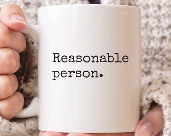 May include: White ceramic mug with black text that reads "Reasonable person."
