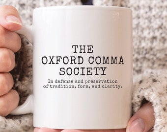 May include: White ceramic mug with black text that reads "THE OXFORD COMMA SOCIETY" and "In defense and preservation of tradition, form, and clarity."