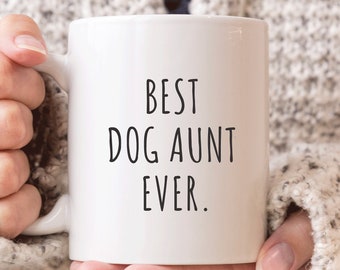 May include: White ceramic mug with black text that reads "BEST DOG AUNT EVER."