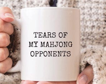 May include: White ceramic coffee mug with black text that reads "Tears of my Mahjong Opponents".