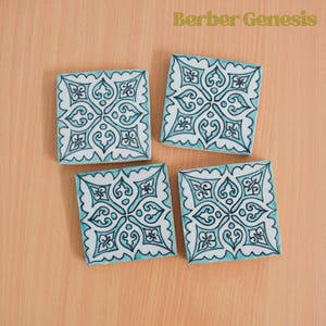Puede incluir: Cuatro posavasos cuadrados de cerámica con un patrón geométrico azul y blanco. Los posavasos presentan un diseño repetitivo de motivos florales estilizados.