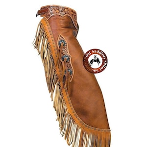May include: Brown leather chaps with fringe and tooled designs. The chaps have a belt loop and a silver concho. The chaps are made by Pilot Saddlery.