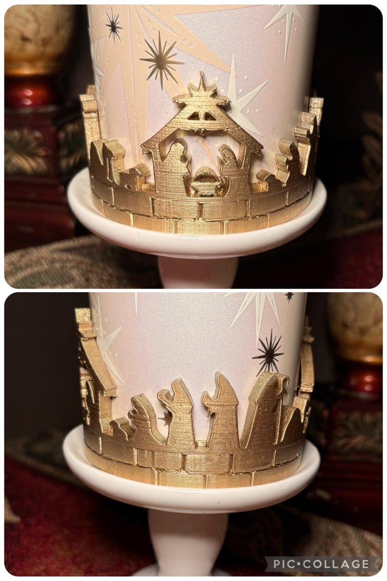 May include: A decorative candle holder featuring a gold-coloured nativity scene and starburst design. The candle holder is white and has a gold-coloured decorative border. The candle holder is on a white pedestal.