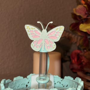 May include: A set of three ceramic mugs with a speckled, matte finish. Each mug features a different color: light blue, cream, and gray. The mugs have a simple, modern design and a comfortable handle. Perfect for coffee or tea.