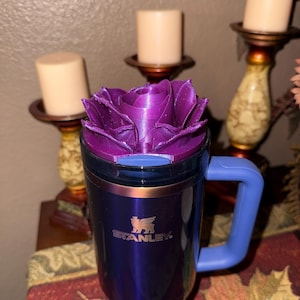 May include: A set of three ceramic mugs with a speckled, matte finish. The mugs are in shades of cream, light gray, and dark gray. Each mug has a simple, minimalist design and a rounded handle.