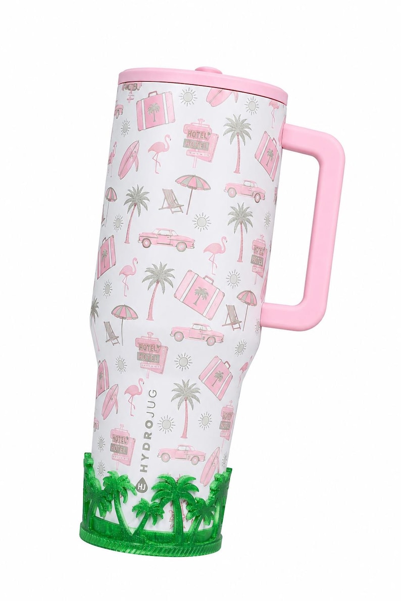 May include: A white tumbler with a pink handle and lid, featuring a repeating pattern of pink flamingos, palm trees, vintage cars, suitcases, and hotel signs. The base is encased in a green silicone sleeve with a palm tree cutout design.