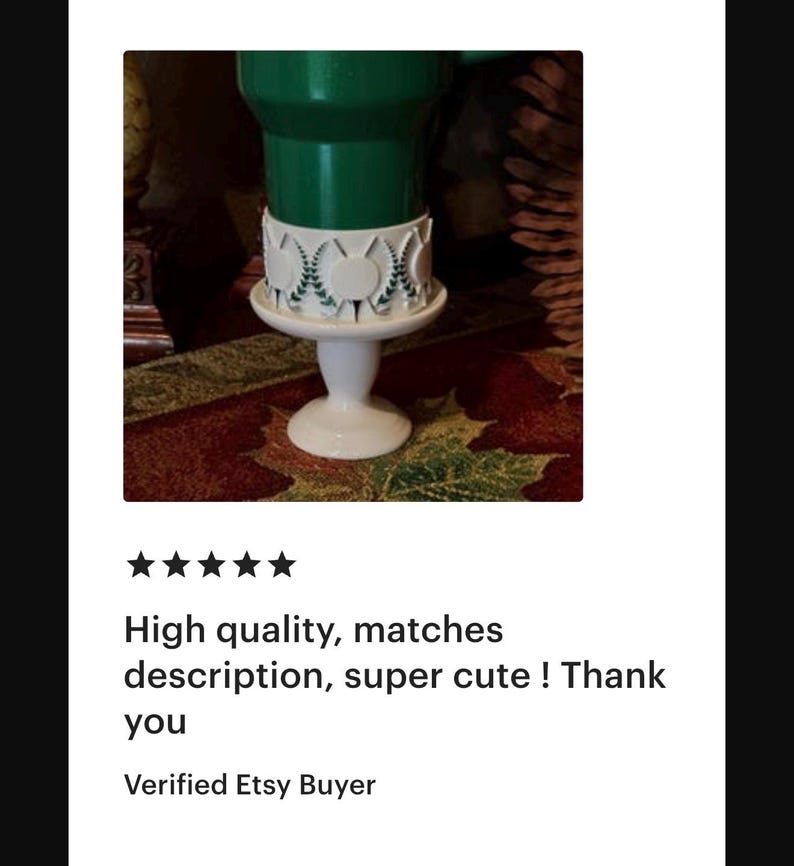 May include: A white, pedestal-style cake stand with a decorative, circular trim. The stand supports a green object. The text on the image says "High quality, matches description, super cute ! Thank you".