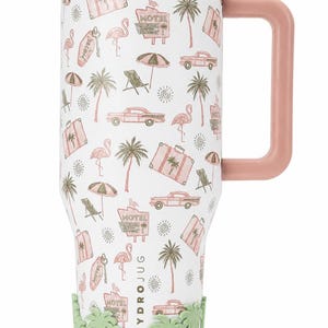 May include: A white tumbler with a pink lid and handle, featuring a repeating pattern of pink flamingos, vintage cars, suitcases, motel signs, palm trees, and suns. A light green silicone base with a palm tree design surrounds the bottom.