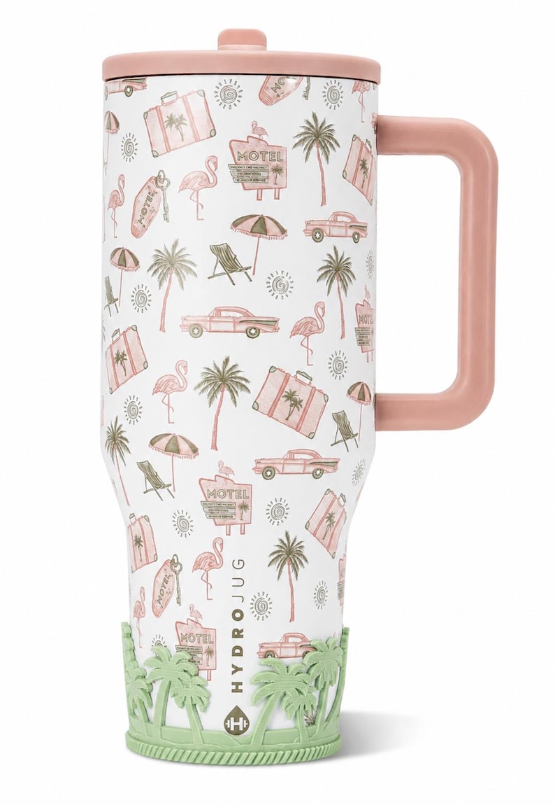 May include: A white tumbler with a pink lid and handle, featuring a repeating pattern of pink flamingos, vintage cars, suitcases, motel signs, palm trees, and suns. A light green silicone base with a palm tree design surrounds the bottom.