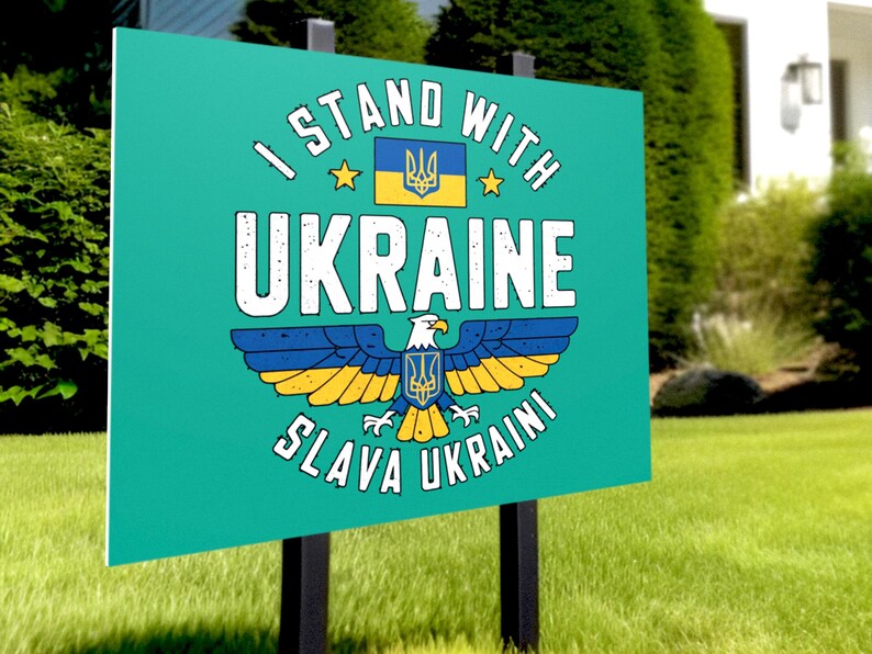 A yard sign mockup displayed on a green lawn in front of a suburban house.  It features the Ukraine Eagle design.