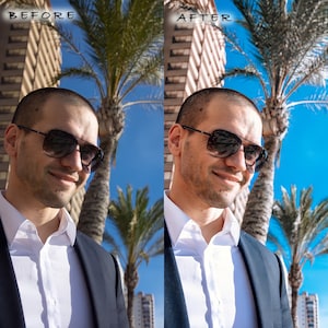 May include: A man wearing a white shirt and a dark blue blazer with a palm tree in the background. He is wearing sunglasses and has a slight smile on his face.