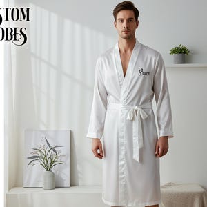 May include: White satin robe with a black embroidered name "Bruce".